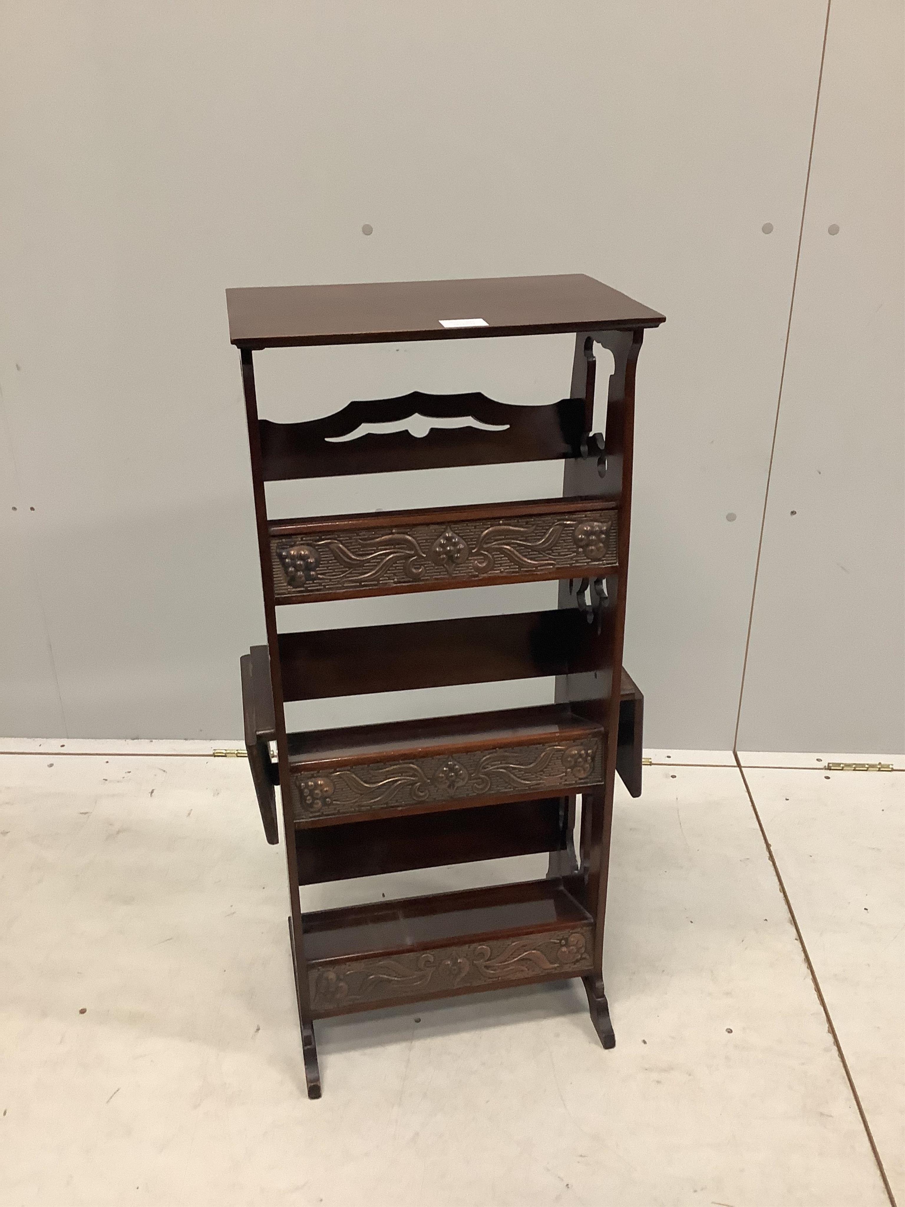 A late 19th century Arts & Crafts mahogany open bookcase, with embossed copper mounted shelf fronts, width 44cm, depth 20cm, height 89cm. Condition - good